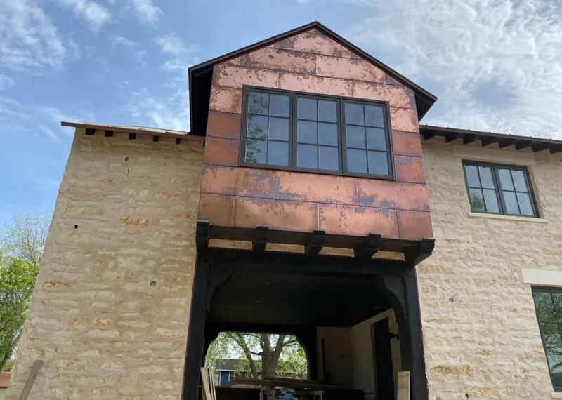 Copper metal panel facade on a stone building for Metal Roof Coating in Fernley