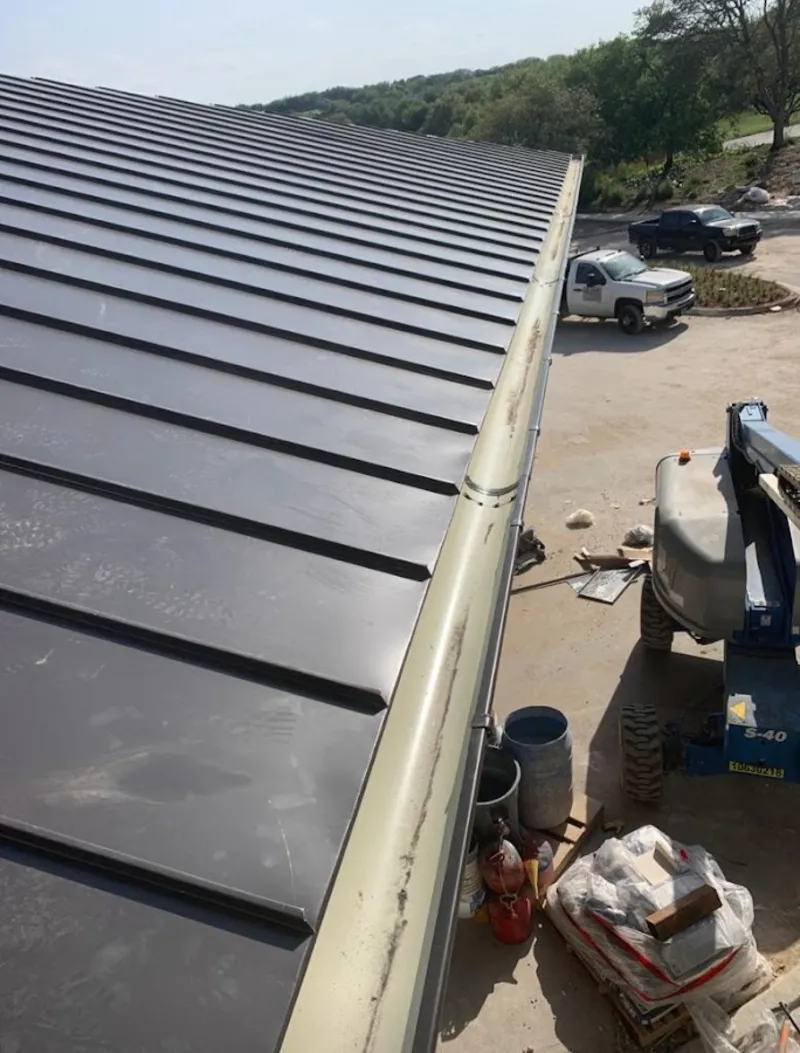 Standing seam panel and gutter detail on a metal roofing jobsite in Fernley